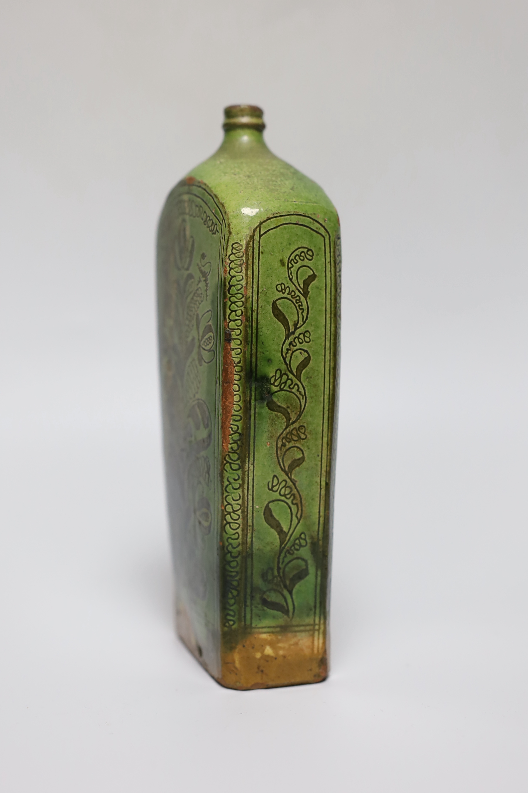 A 19th century green glazed terracotta Sgraffito flask, 19cm